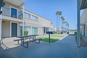 Long Beach Affordable Apartments for Rent - Seaport Village Apartments - Courtyard with BBQ Area, Picnic Table, Exterior of Building