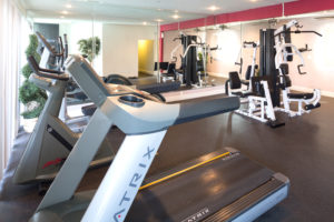 Fitness center with various machines and mirrors